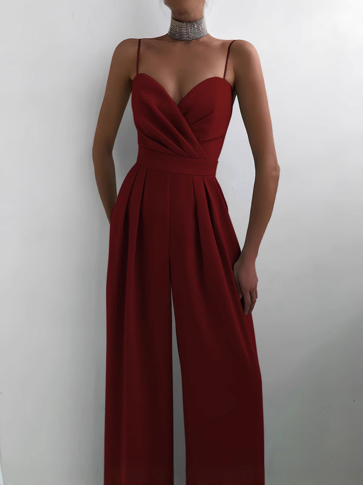 Modny damski kombinezon w jednolitym kolorze z szerokimi nogawkami i szeroką talią, bez rękawów i szelkami